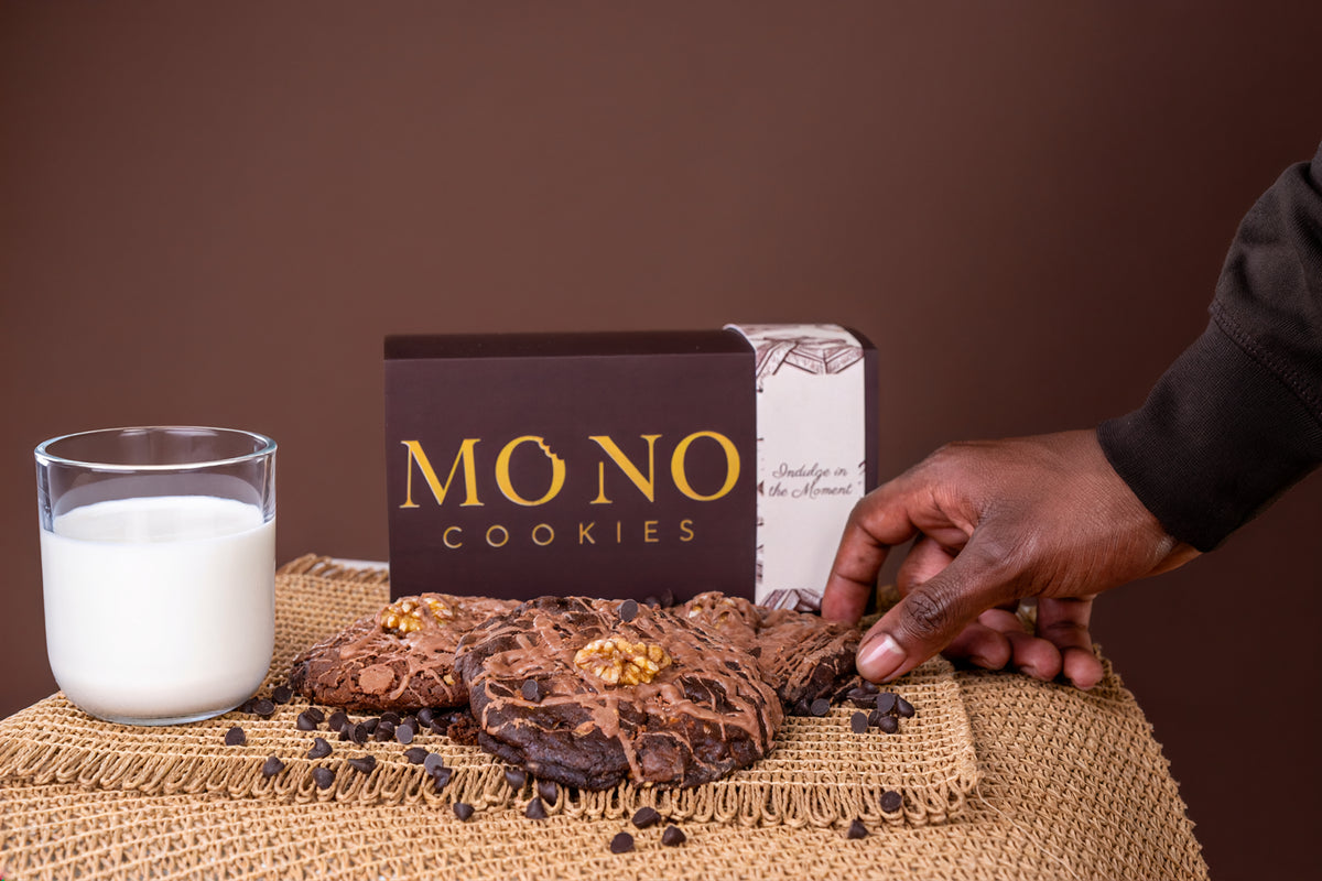 A hand reaching for a MONO cookie